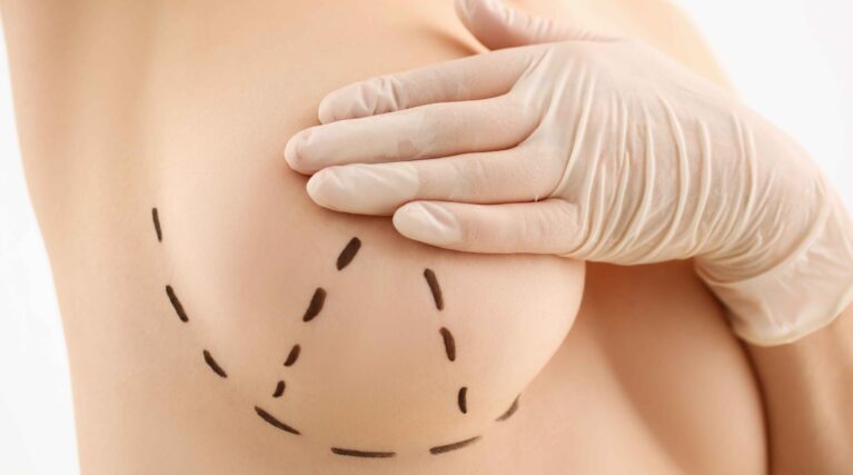 female-hand-gloves-holding-breast-closeup-2-scaled